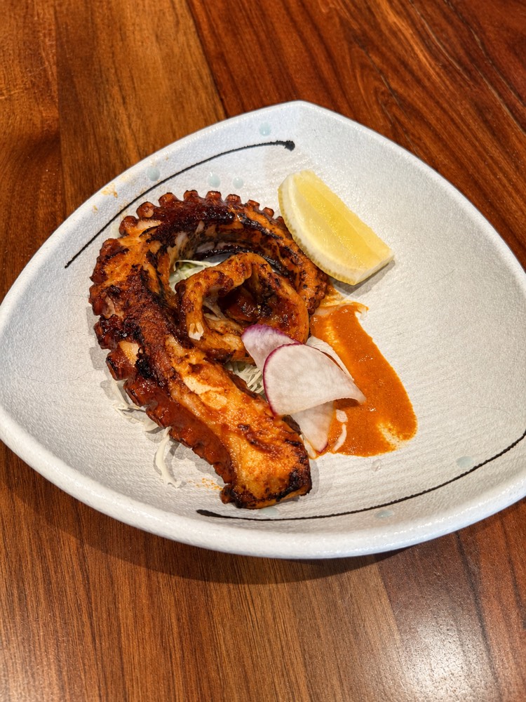 Grilled octopus plated with lemon