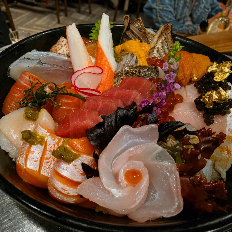 Chef's assorted sashimi platter with uni, caviar, and gold leaf