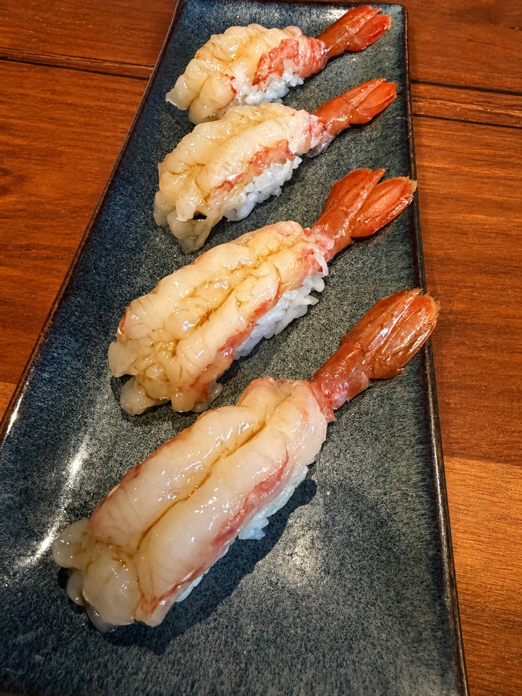 Shrimp nigiri on a slate plate
